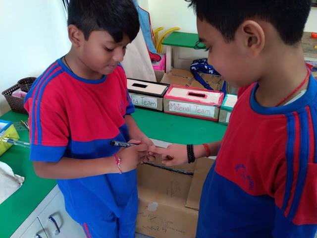 A child having ink applied to a finger at a T-LAB election