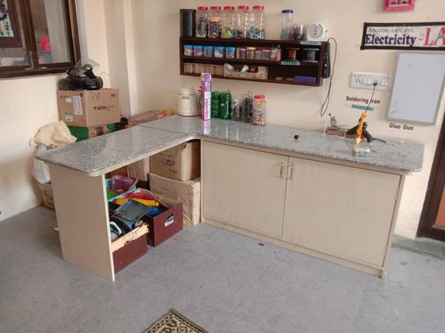 A tidy corner workbench with storage drawers and shelves